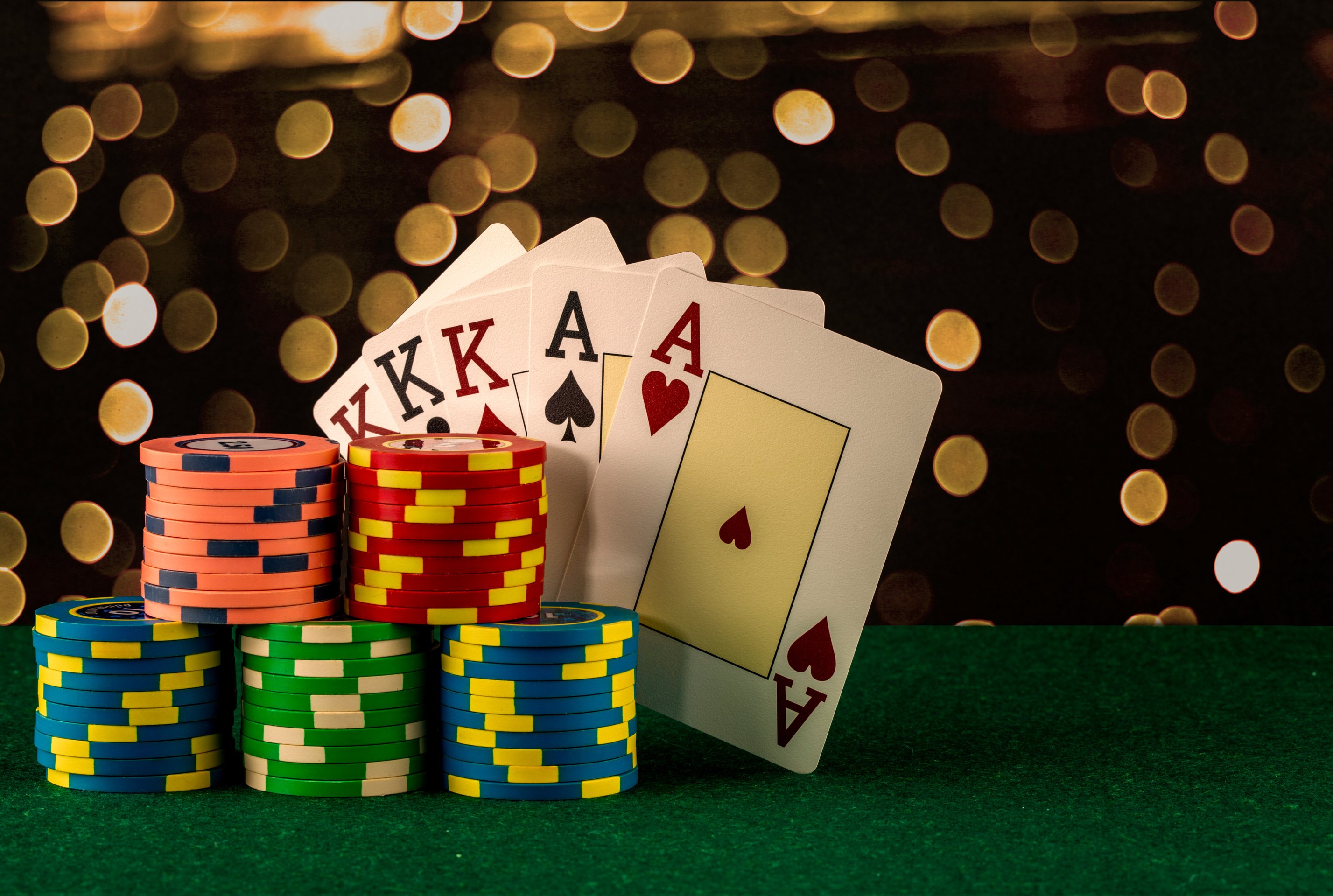 Casino Chips, Poker Cards and Money on Blurred Background